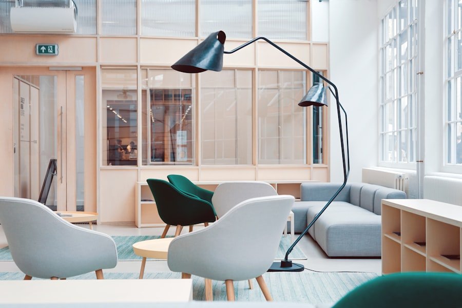 Modern office lounge furnished with chairs, tables and storage units